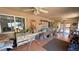 Enclosed sun room with tiled floors, multiple windows, and ceiling fans at 4910 Marywood Ct, Pahrump, NV 89061