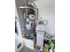Image features a standard water heater with an attached water softener system at 4910 Marywood Ct, Pahrump, NV 89061