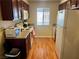 Compact kitchen featuring white appliances, laminate floors, and wood cabinets at 5020 Indian River Dr # 432, Las Vegas, NV 89103