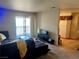 Carpeted living room with patio access and view into the kitchen at 5020 Indian River Dr # 432, Las Vegas, NV 89103