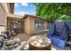 Back patio area, partially shaded by trees, with patio seating and access to the home at 5083 Village Dr, Las Vegas, NV 89142