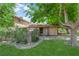 Charming single story home featuring a well-maintained lawn and mature trees at 5083 Village Dr, Las Vegas, NV 89142