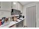 A look at the kitchen featuring white cabinets and essential appliances at 5083 Village Dr, Las Vegas, NV 89142