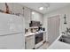 Compact kitchen with white cabinetry and appliances at 5083 Village Dr, Las Vegas, NV 89142