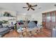 Open living area with ceiling fan, wood floors, and view into the kitchen area at 5083 Village Dr, Las Vegas, NV 89142
