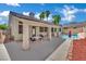 Spacious backyard featuring a sparkling pool, covered patio, and lush landscaping, perfect for outdoor entertaining at 5509 Rose Thicket St, Las Vegas, NV 89130