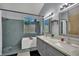 Bathroom with a double vanity, shower, and soaking tub at 5509 Rose Thicket St, Las Vegas, NV 89130
