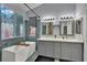Bathroom with a double vanity, shower, and soaking tub at 5509 Rose Thicket St, Las Vegas, NV 89130