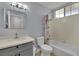 Neutral bathroom featuring a shower-tub combination with white tiling and a gray vanity with a solid surface counter at 5509 Rose Thicket St, Las Vegas, NV 89130