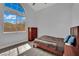 Cozy bedroom with vaulted ceilings, wood-look floors, a bright window, and simple, stylish furniture at 5509 Rose Thicket St, Las Vegas, NV 89130