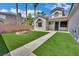 Charming home with artificial turf, a fire pit, and well-maintained landscaping at 5509 Rose Thicket St, Las Vegas, NV 89130