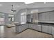 Open kitchen with gray cabinets, stainless steel appliances, and tile floors at 5509 Rose Thicket St, Las Vegas, NV 89130