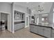 Open kitchen with gray cabinets, stainless steel appliances, and tile floors at 5509 Rose Thicket St, Las Vegas, NV 89130