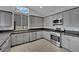 Charming kitchen with grey cabinets and stainless steel appliances at 5509 Rose Thicket St, Las Vegas, NV 89130