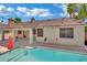 Inviting backyard pool with covered patio, ideal for relaxation and leisure, enhanced by festive string lights at 5509 Rose Thicket St, Las Vegas, NV 89130