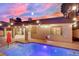 The home's backyard and pool are picturesque, with festive lighting at 5509 Rose Thicket St, Las Vegas, NV 89130
