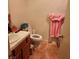 Small bathroom with a sink, toilet, and a pink towel hanging on the wall at 561 E Bourbon St, Pahrump, NV 89048