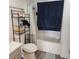 Well-lit bathroom features a shower with curtain and towel rack, and a toilet, creating a practical space at 561 E Bourbon St, Pahrump, NV 89048