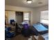 Bright bedroom with a sliding mirrored closet door and window with blinds at 561 E Bourbon St, Pahrump, NV 89048