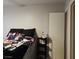 Simple bedroom with a bed, and a view of the door and white walls at 561 E Bourbon St, Pahrump, NV 89048
