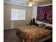 Cozy bedroom with a ceiling fan and a large window at 561 E Bourbon St, Pahrump, NV 89048