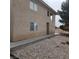Exterior view of the property with a gravel front, a sidewalk, and two floors at 561 E Bourbon St, Pahrump, NV 89048
