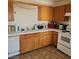 Bright kitchen featuring wooden cabinets, tiled countertops, and modern appliances at 561 E Bourbon St, Pahrump, NV 89048