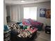 Bright living room featuring light wood floors, ample natural light, and simple furnishings at 561 E Bourbon St, Pahrump, NV 89048