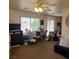 Living room with a window, sliding door, and assorted furniture at 561 E Bourbon St, Pahrump, NV 89048