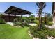 Spacious backyard with a covered patio, artificial grass, and drought-tolerant landscaping at 5761 E Badlands Ln, Pahrump, NV 89061