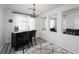 Bright dining area features a chandelier, bar with seating, and modern finishes at 5761 E Badlands Ln, Pahrump, NV 89061