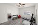 Well-lit exercise room with workout equipment, a ceiling fan, and a view into the bedroom at 5761 E Badlands Ln, Pahrump, NV 89061