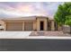 Charming single-story home with a three-car garage, desert landscaping, and a welcoming entrance at 5761 E Badlands Ln, Pahrump, NV 89061
