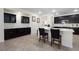 Modern kitchen with black cabinetry, stainless steel appliances, and a large quartz countertop island at 5761 E Badlands Ln, Pahrump, NV 89061
