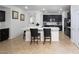 Modern kitchen with black cabinetry, stainless steel appliances, and a large quartz countertop island at 5761 E Badlands Ln, Pahrump, NV 89061