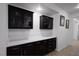 Modern kitchen with black cabinetry and stylish decor, including an abundance of counter space at 5761 E Badlands Ln, Pahrump, NV 89061