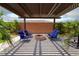 Charming patio featuring a fire pit, modern seating, and a stylish pergola for outdoor relaxation at 5761 E Badlands Ln, Pahrump, NV 89061