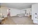 Large bedroom features a queen bed, a wall mirror, and views to the hallway and ensuite bathroom at 5907 Zawawi Ct, Las Vegas, NV 89110