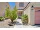 Inviting home entrance with desert landscaping, walkway, and covered porch, creating a welcoming first impression at 5907 Zawawi Ct, Las Vegas, NV 89110