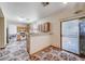 Eat-in kitchen features light wood cabinetry, neutral countertops, and a sliding glass door to the exterior at 5907 Zawawi Ct, Las Vegas, NV 89110