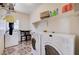 Functional laundry room with washer, dryer, and storage shelves at 5907 Zawawi Ct, Las Vegas, NV 89110