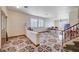 Open-concept living area with tile flooring, staircase, and abundant natural light, perfect for entertaining at 5907 Zawawi Ct, Las Vegas, NV 89110