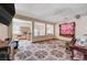 Open-concept living area with tile flooring, staircase, and abundant natural light, perfect for entertaining at 5907 Zawawi Ct, Las Vegas, NV 89110