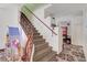 Carpeted staircase with decorative wrought-iron railing leads to the upper level at 5907 Zawawi Ct, Las Vegas, NV 89110