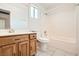 Well-lit bathroom features a single sink vanity, toilet, and shower over tub at 5921 Royal Castle Ln, Las Vegas, NV 89130