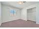 Bright bedroom with light pink carpet, base trim, closet, and a window allowing for natural light at 5921 Royal Castle Ln, Las Vegas, NV 89130