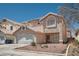 Two-story home with a tile roof, low maintenance desert landscaping, and a two-car garage at 5921 Royal Castle Ln, Las Vegas, NV 89130