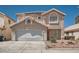 Charming two-story home featuring a tile roof, a two-car garage, and neutral exterior paint at 5921 Royal Castle Ln, Las Vegas, NV 89130