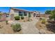 Spacious backyard with desert landscaping, rock pathways, and covered patio, perfect for relaxing at 6808 Mystic Plain Ct, Las Vegas, NV 89149