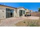 Cozy backyard with a brick patio, two sliding glass doors, and low-maintenance desert landscaping at 6808 Mystic Plain Ct, Las Vegas, NV 89149